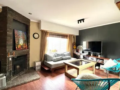 a living room with a couch and a fireplace at Casa alojamiento in Cordoba