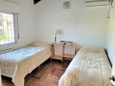 a bedroom with two beds and a table with a lamp at Crin Blanca in Cordoba
