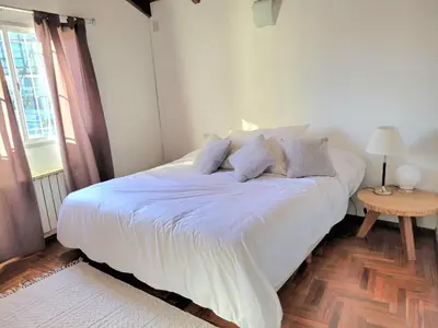 a white bed with pillows on it in a bedroom at Crin Blanca in Cordoba