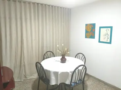 a white table with chairs and a vase on it at Departamento Barrio General Paz in Cordoba