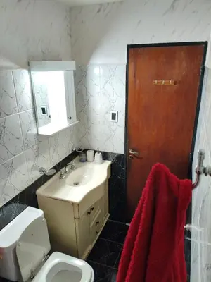a bathroom with a sink and a toilet and a mirror at Departamento Barrio General Paz in Cordoba