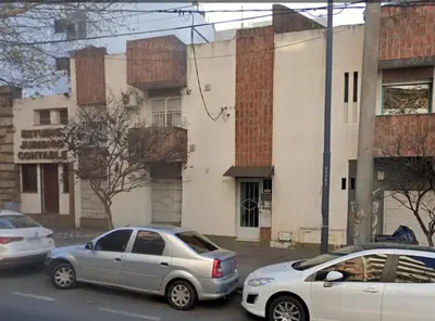 two cars parked in a parking lot in front of a building at Departamento Barrio General Paz in Cordoba