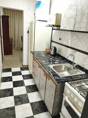 a kitchen with a black and white checkered floor at Departamento Barrio General Paz in Cordoba