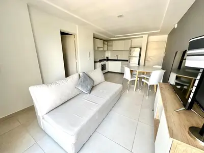 a living room with a white couch and a table at Alojamiento entero para 2 personas E in Cordoba