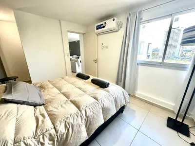 a bedroom with a bed and a large window at Alojamiento entero para 2 personas E in Cordoba