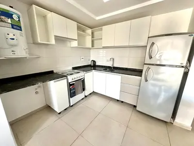 a kitchen with white cabinets and a stainless steel refrigerator at Alojamiento entero para 2 personas E in Cordoba
