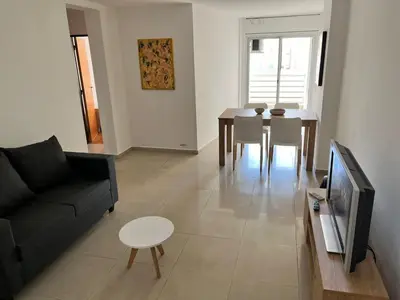 a living room with a couch and a table and a tv at Jardines del Boulevard 6 in Cordoba