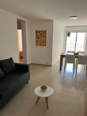 a living room with a black couch and a table at Jardines del Boulevard 6 in Cordoba