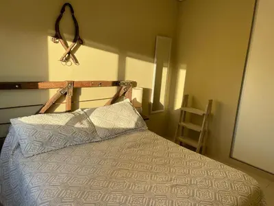 a bedroom with a bed with a pair of scissors on the wall at Departamento en Altos de Villa Sol y Seguridad 24h - Córdoba, Argentina in Cordoba