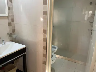 a bathroom with a shower and a toilet and a sink at Departamento en Altos de Villa Sol y Seguridad 24h - Córdoba, Argentina in Cordoba