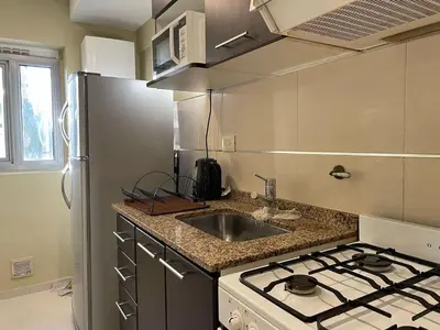 a kitchen with a sink and a stove top oven at Departamento en Altos de Villa Sol y Seguridad 24h - Córdoba, Argentina in Cordoba