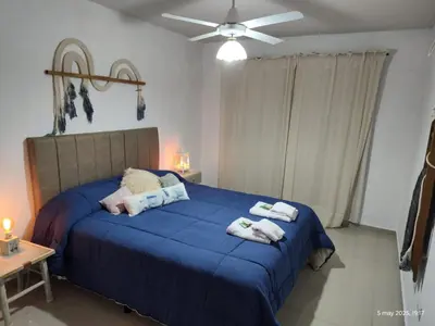 a bedroom with a blue bed with towels on it at Espacio PAN in Villa Carlos Paz