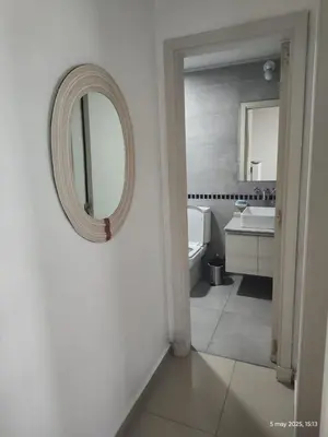a white bathroom with a mirror and a sink at Espacio PAN in Villa Carlos Paz