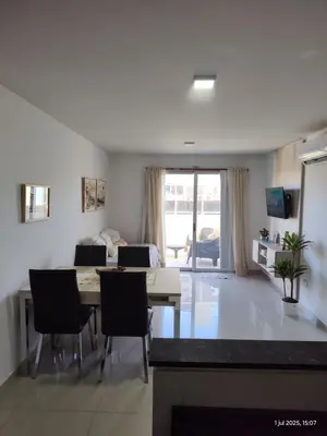 a kitchen and dining room with a table and chairs at Espacio PAN in Villa Carlos Paz
