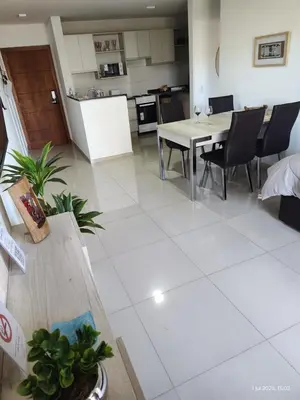 a kitchen and dining room with a table and chairs at Espacio PAN in Villa Carlos Paz