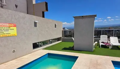 a swimming pool on the roof of a building at Espacio PAN in Villa Carlos Paz