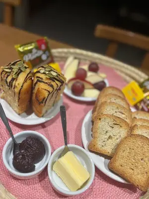 a table topped with plates of bread and pastries at Complejo de Cabañas Aires de Santiago in San Antonio de Arredondo