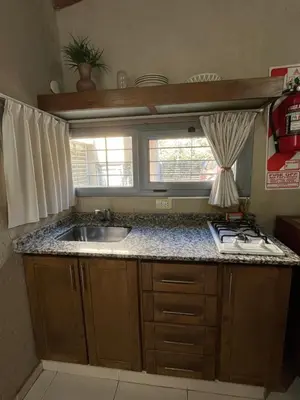 a small kitchen with a sink and a window at Complejo de Cabañas Aires de Santiago in San Antonio de Arredondo