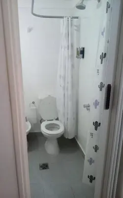a white bathroom with a toilet and a sink at Monoambiente Centro villa Carlos Paz in Villa Carlos Paz