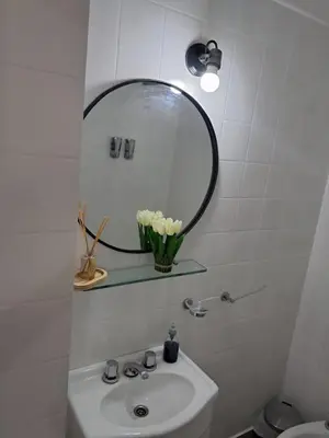 a bathroom with a sink and a mirror on the wall at Monoambiente Centro villa Carlos Paz in Villa Carlos Paz
