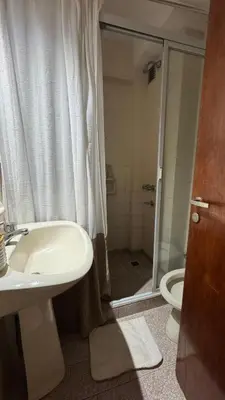 a bathroom with a sink and a shower with a toilet at Ayacucho loft in Cordoba