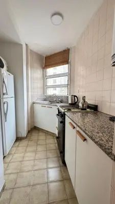 a kitchen with a sink and a stove top oven at Ayacucho loft in Cordoba