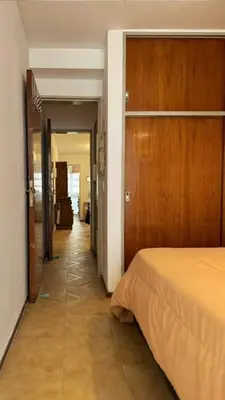 a hallway leading to a bedroom with a bed at Ayacucho loft in Cordoba
