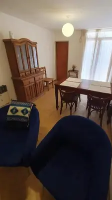 a living room with a blue chair and a table at Ayacucho loft in Cordoba