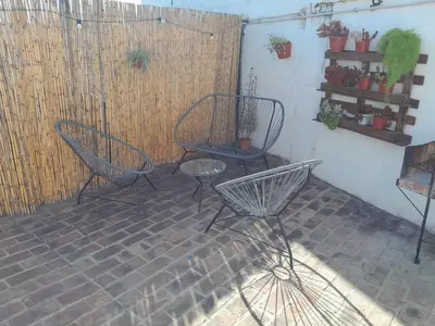 two chairs and a table on a patio at Departamento La Cuesta in Villa Carlos Paz