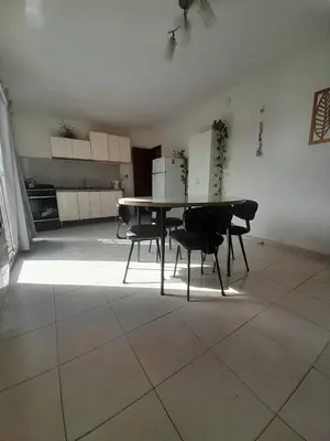 a dining room with a table and some chairs at Departamento La Cuesta in Villa Carlos Paz