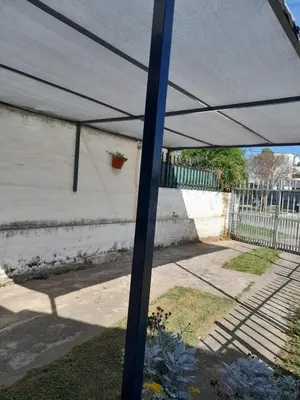 a blue pole with a tent in a yard at Departamento La Cuesta in Villa Carlos Paz