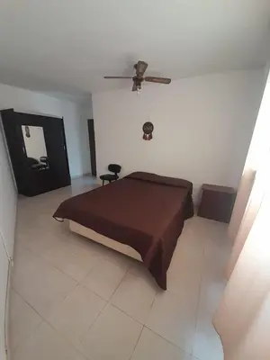 a bedroom with a bed and a ceiling fan at Departamento La Cuesta in Villa Carlos Paz