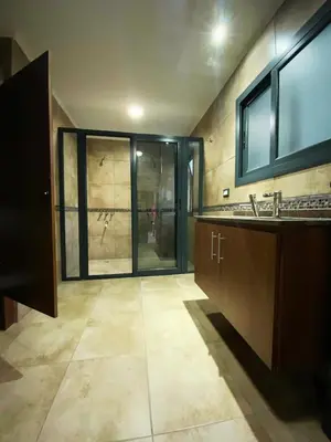 a bathroom with a sink and a large window at Departamento con cochera y piscina centro Carlos Paz in Villa Carlos Paz