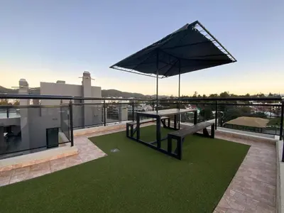 a picnic table on the roof of a building at Departamento con cochera y piscina centro Carlos Paz in Villa Carlos Paz