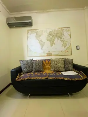 a couch in a room with a map on the wall at Departamento con cochera y piscina centro Carlos Paz in Villa Carlos Paz