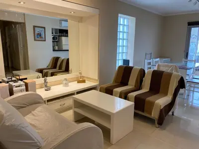 a living room with two chairs and a mirror at Alquiler del Departamento Barrio residencial in Cordoba