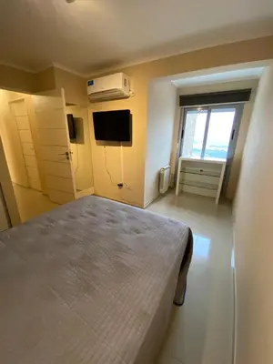 a bedroom with a large bed and a window at Alquiler del Departamento Barrio residencial in Cordoba