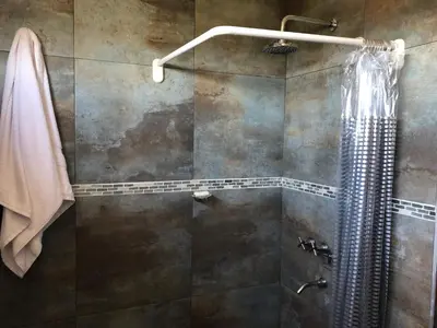 a bathroom with a shower with a shower curtain at Nuestro lugar en Traslasierra in Los Hornillos