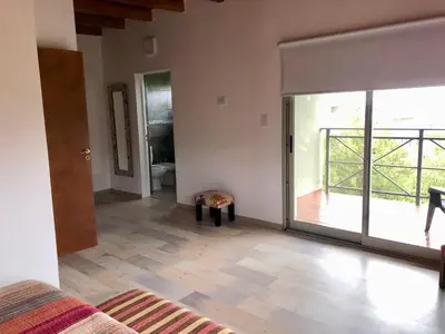 a living room with a large sliding glass door at Nuestro lugar en Traslasierra in Los Hornillos