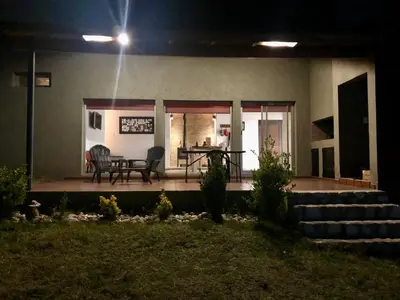 a patio at night with a table and chairs at Nuestro lugar en Traslasierra in Los Hornillos
