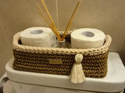 a basket on top of a toilet with toilet paper at Departamento en Complejo Villa Sol in Cordoba