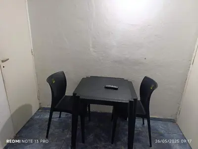 a black table with two chairs and a remote control on it at Violeta in Cordoba