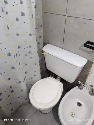 a bathroom with a white toilet and a sink at Violeta in Cordoba