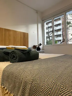 a bedroom with a large bed with a large window at Monoambiente en el centro de Córdoba in Cordoba