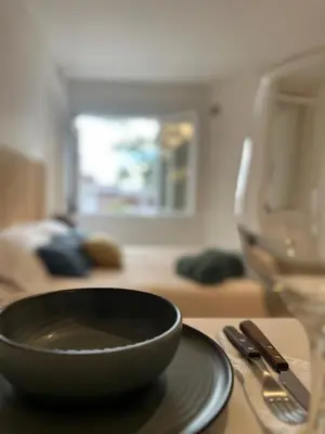 a black bowl sitting on a table next to a glass at Monoambiente en el centro de Córdoba in Cordoba