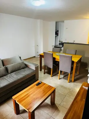 a living room with a couch and a table at Departamento Carlos Paz in Villa Carlos Paz