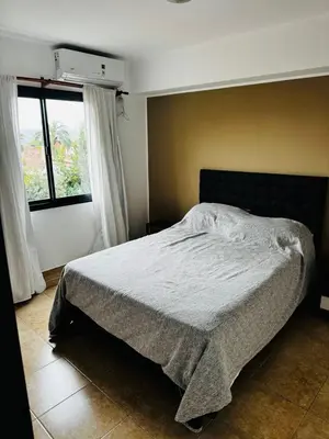 a bedroom with a bed and a window at Departamento Carlos Paz in Villa Carlos Paz