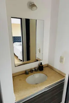 a bathroom with a sink and a mirror at Departamento Carlos Paz in Villa Carlos Paz