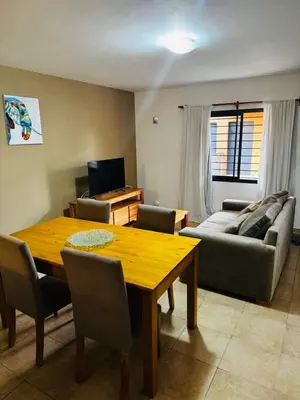 a living room with a wooden table and a couch at Departamento Carlos Paz in Villa Carlos Paz