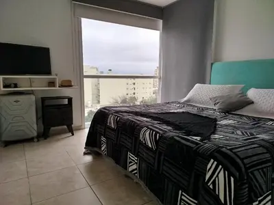 a bedroom with a bed and a large window at Departamento 1 dormitorio in Cordoba